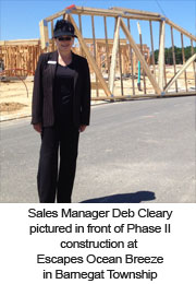 Sales Manager Deb Cleary pictured in front of Phase II construction at Escapes Ocean Breeze in Barnegat Township